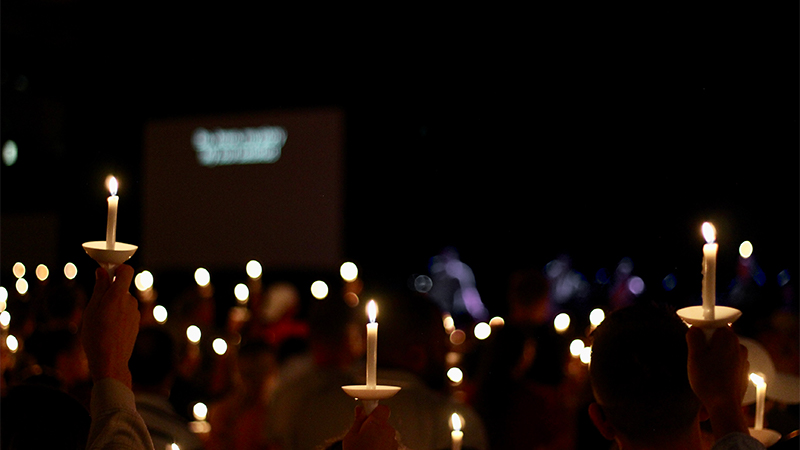 Photo of multiple candle lights in the dark